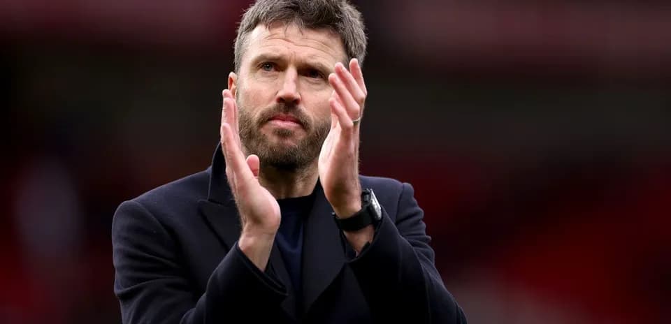 Manager applauding fans after the match