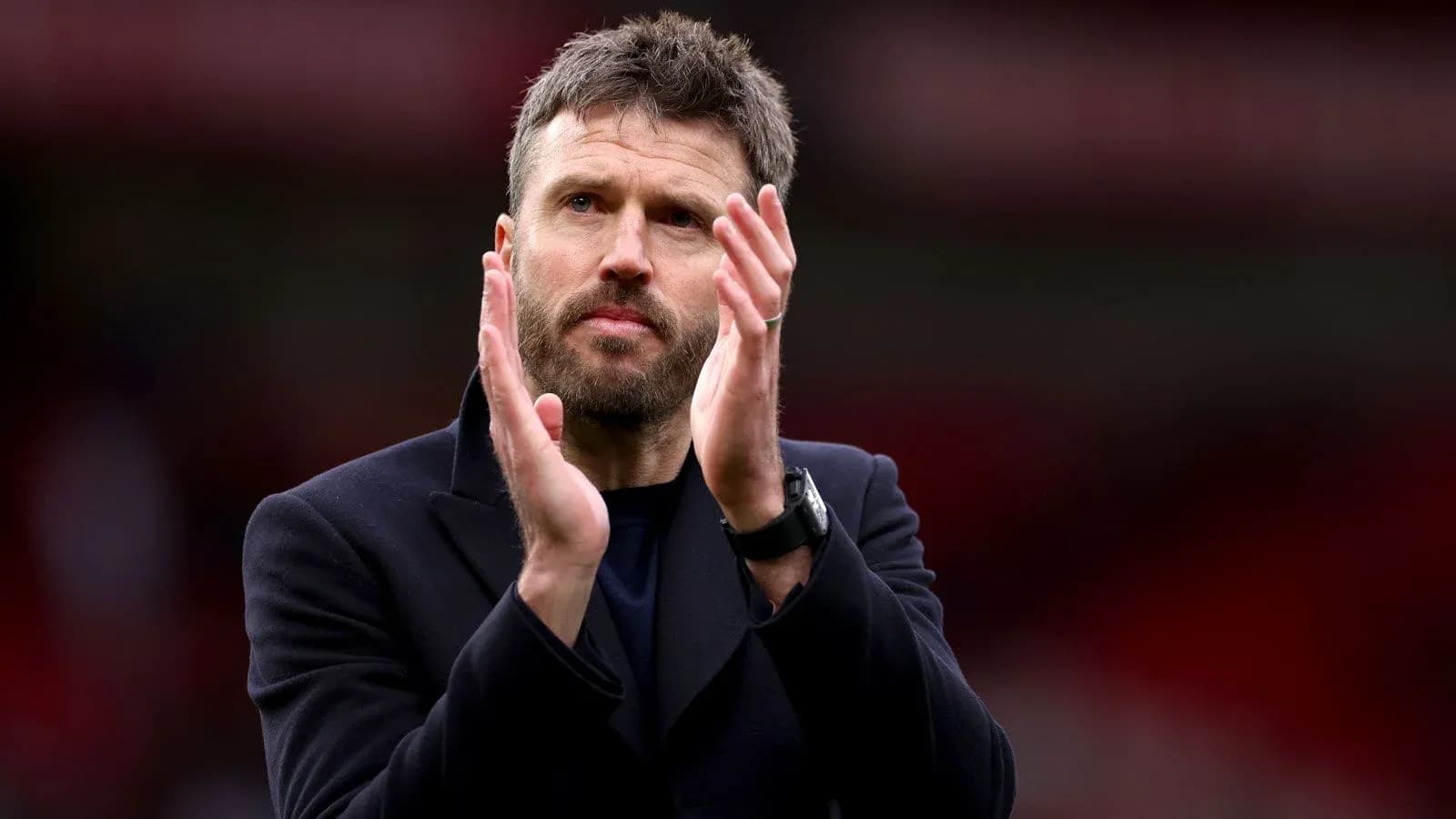 Manager applauding fans after the match