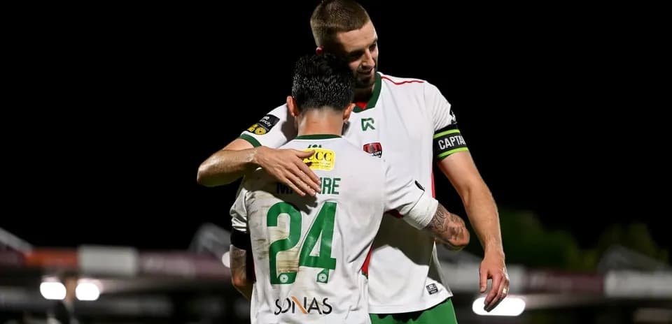 Two players embracing on the field after a match
