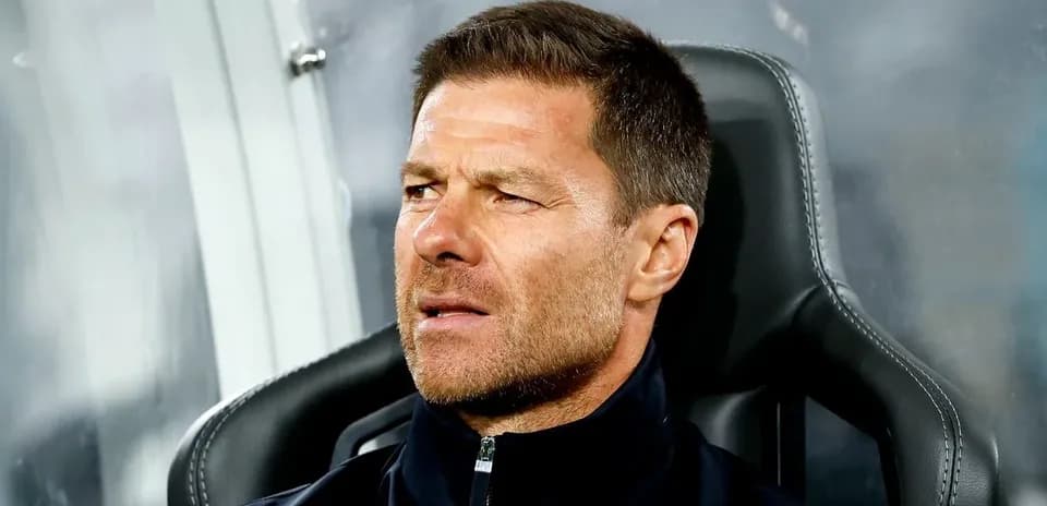 Coach seated on bench during a match