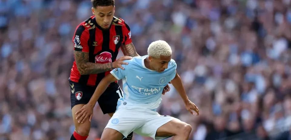 Bournemouth player tackles Manchester City player during match