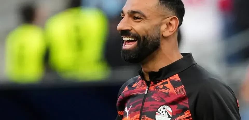 Player smiling during warm-up session on pitch