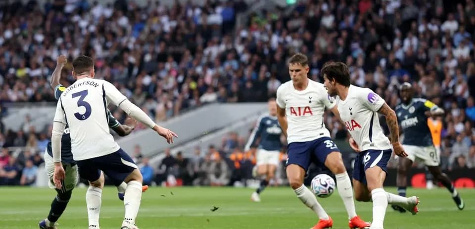 Players from Tottenham defending against an attacking player