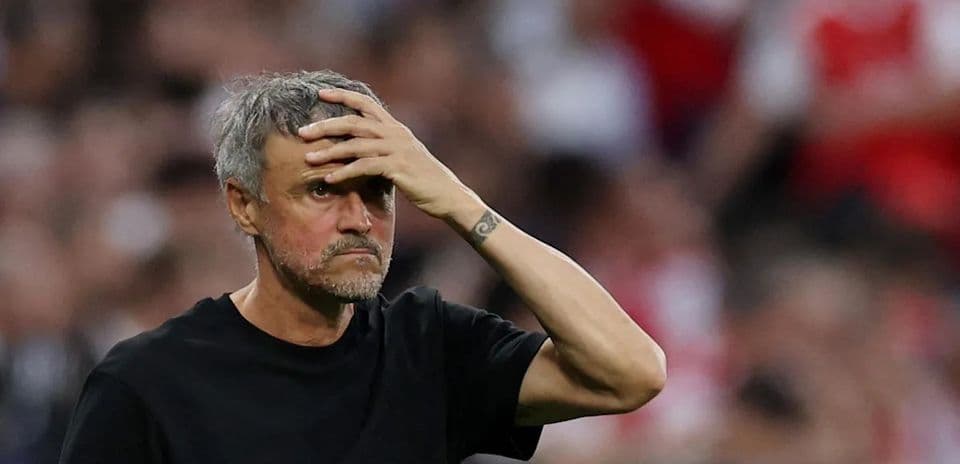 Coach observing match with hand on forehead