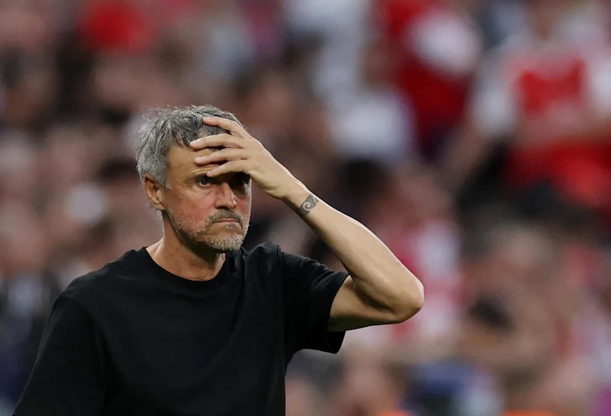 Coach observing match with hand on forehead
