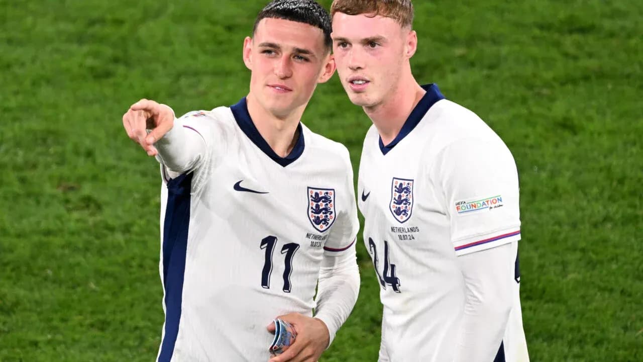 Two England players discussing on the pitch