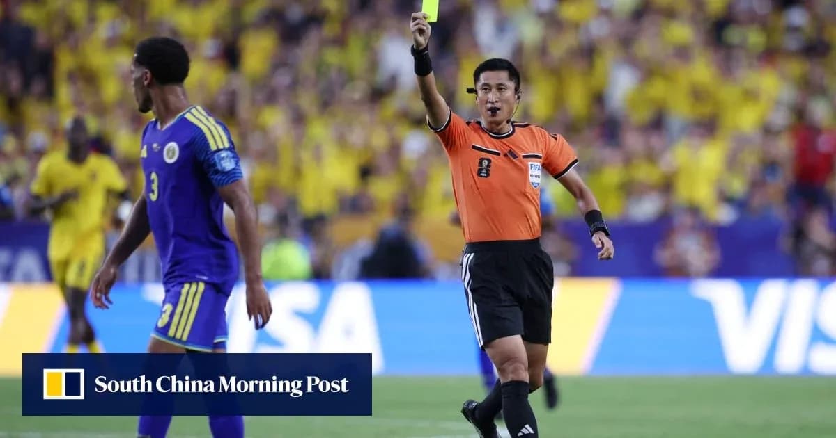Referee showing yellow card to player during match Referee showing yellow card to player during match