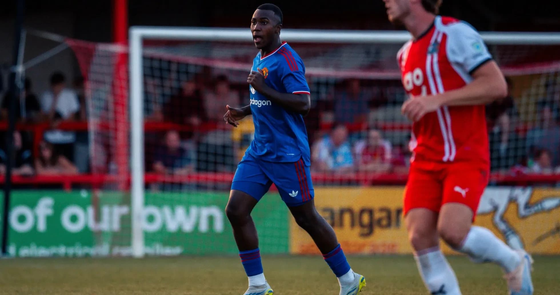 Player in blue kit running during football match