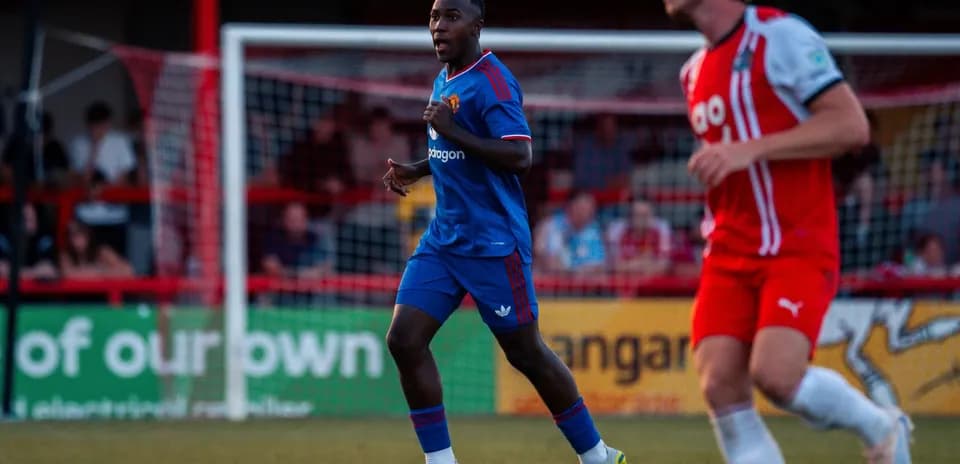 Player in blue kit running during football match