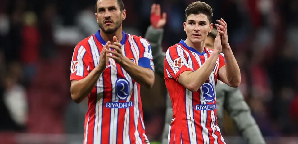 Two players applauding fans after the match