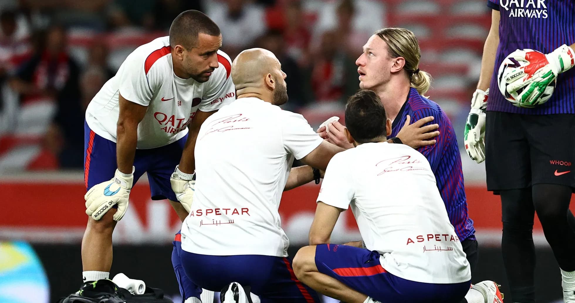 Medical staff attending to player on the field