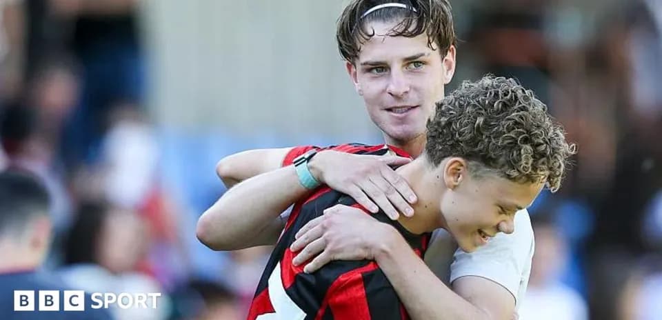 Two football players embracing after a match