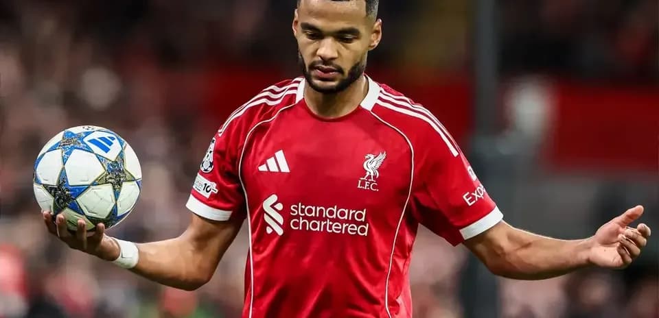Player in red Liverpool kit holding a football