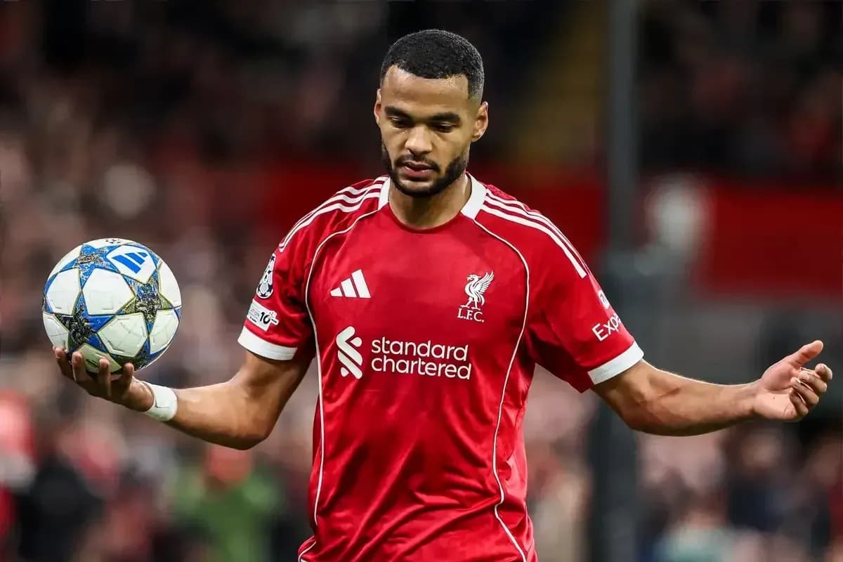 Player in red Liverpool kit holding a football