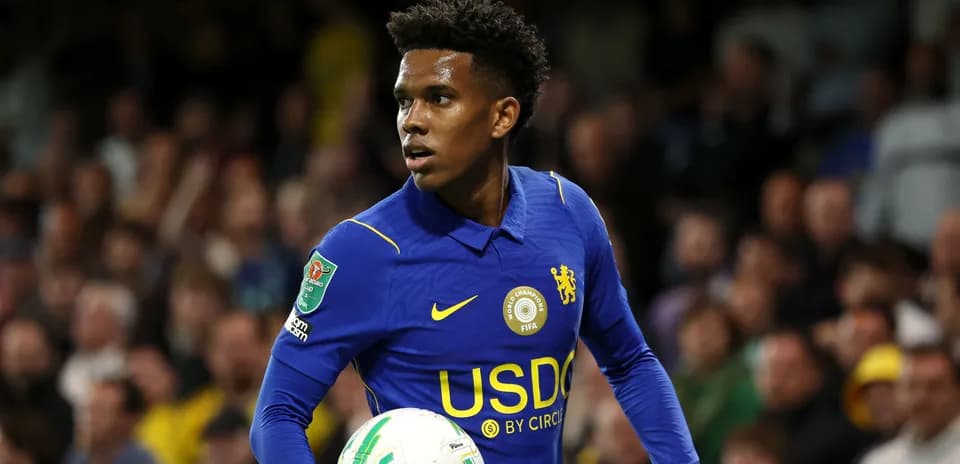 Player in blue jersey holding football during match