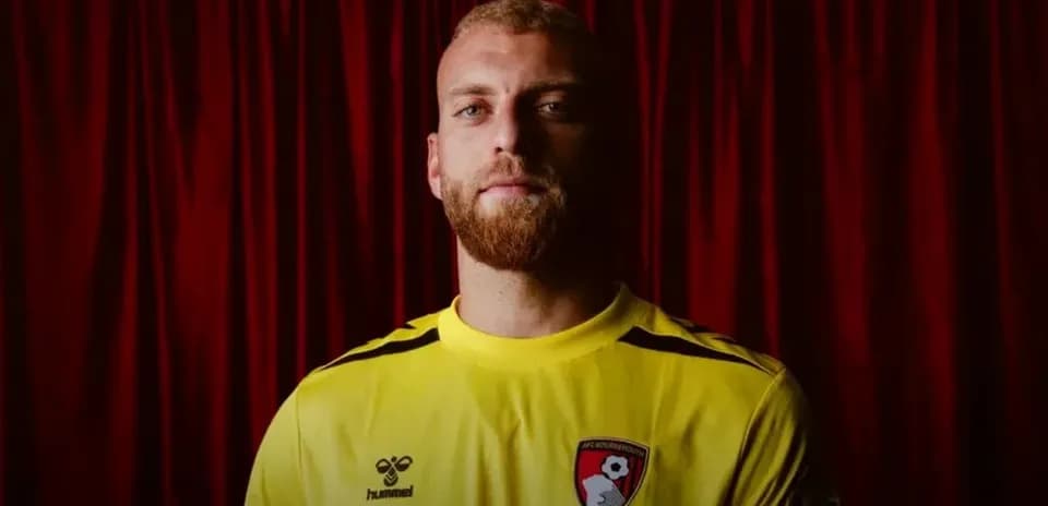 Goalkeeper posing in AFC Bournemouth jersey