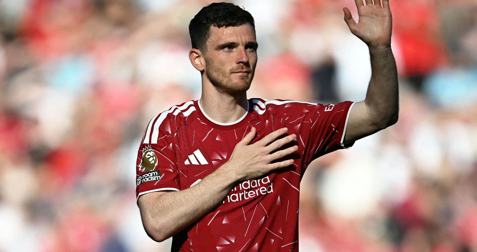 Player waving with hand over heart in jersey