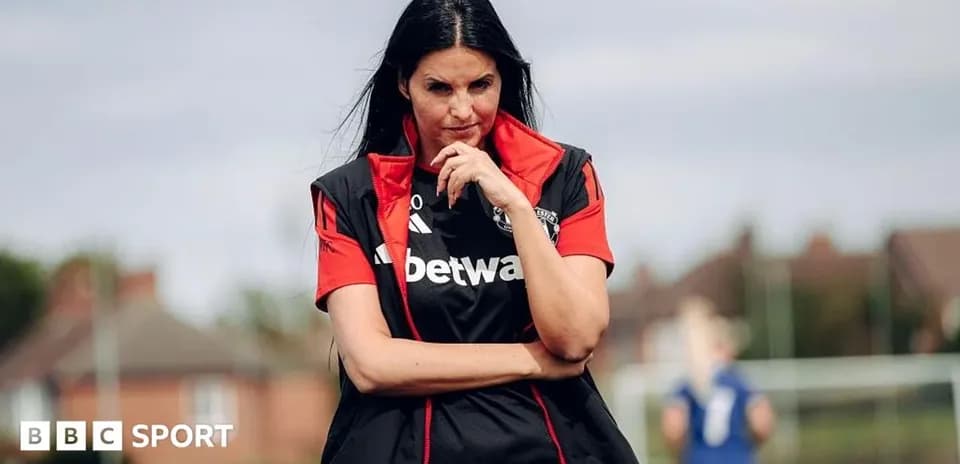 Female coach observing players during training session