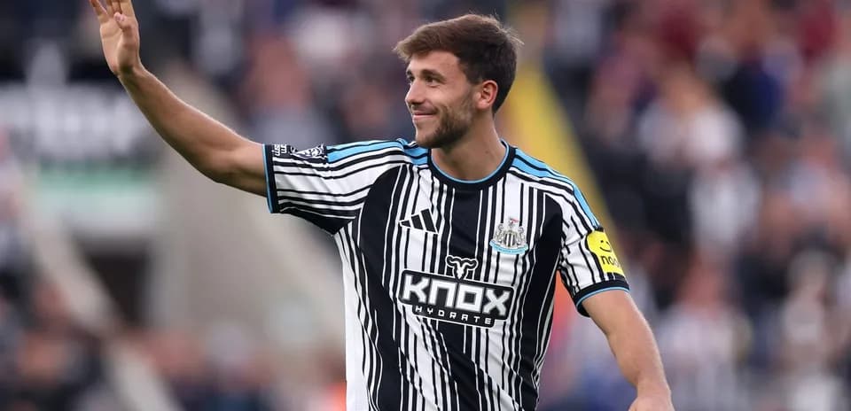 Newcastle player waving to fans during match