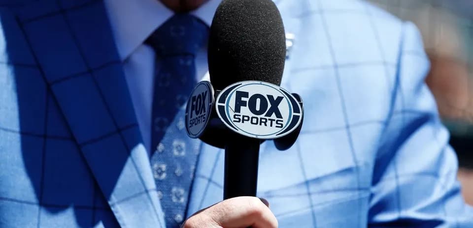 Microphone with FOX Sports logo held by presenter