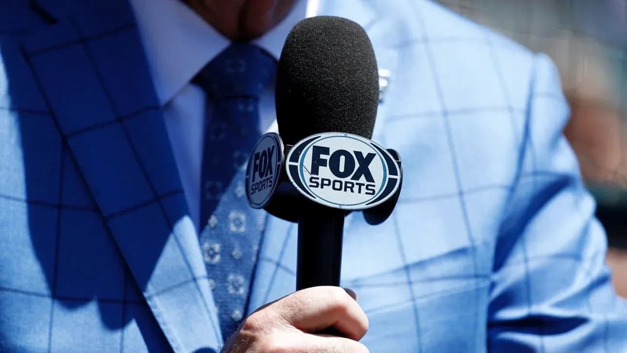 Microphone with FOX Sports logo held by presenter