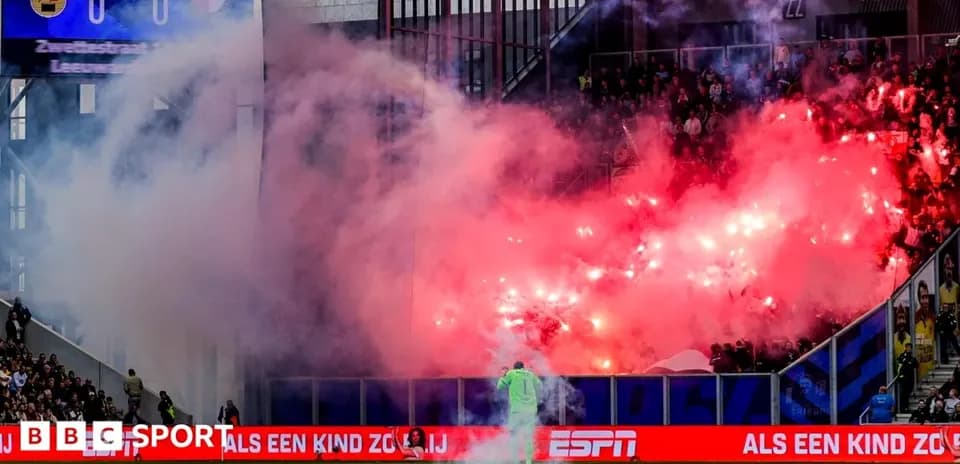 Fans celebrating with flares during a football match