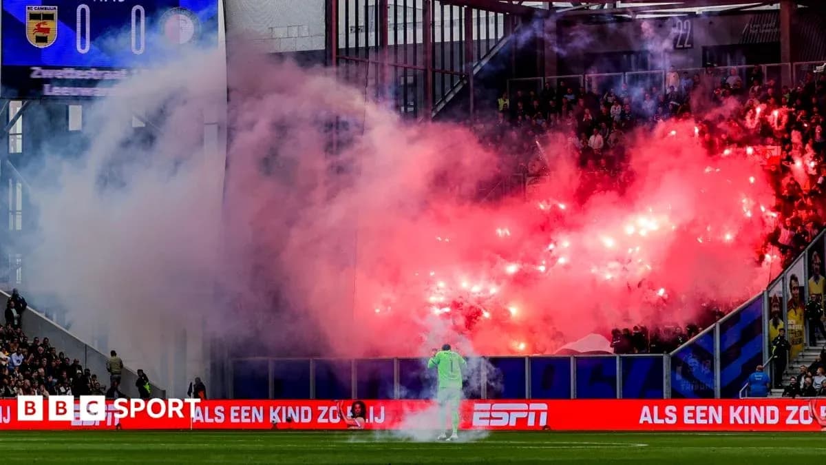 Fans celebrating with flares during a football match