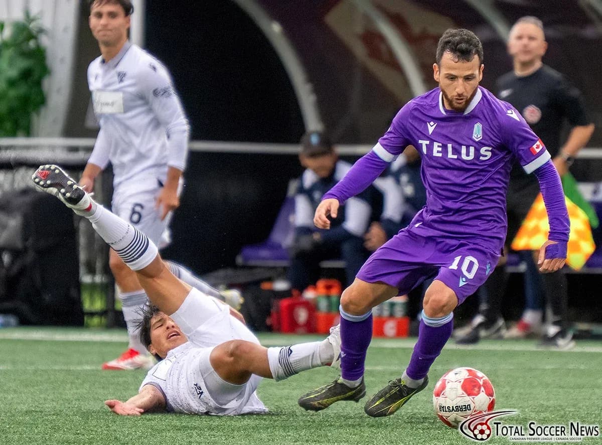 Player evading tackle during Vancouver FC match