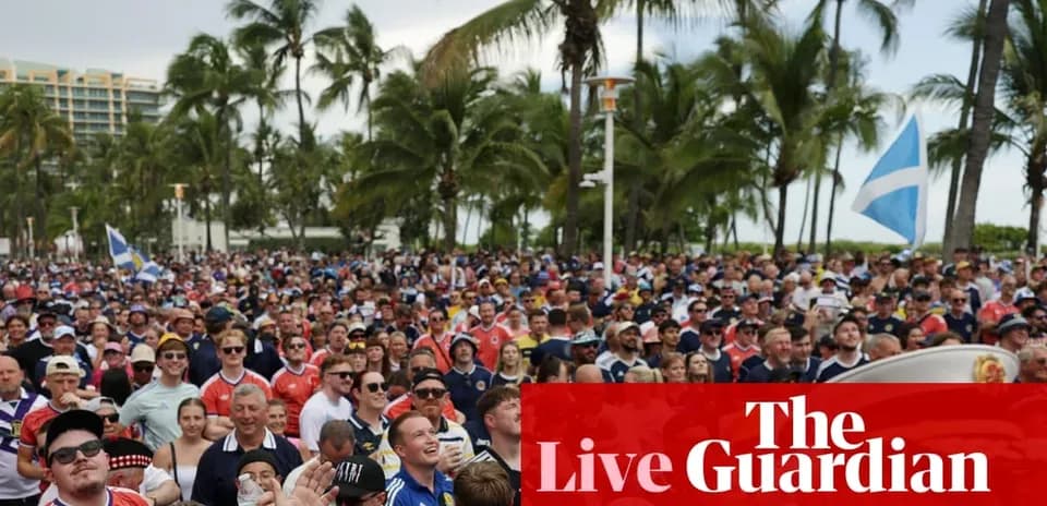 Large crowd of fans at outdoor event with flags