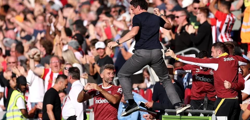 Manager celebrating with fans during a match