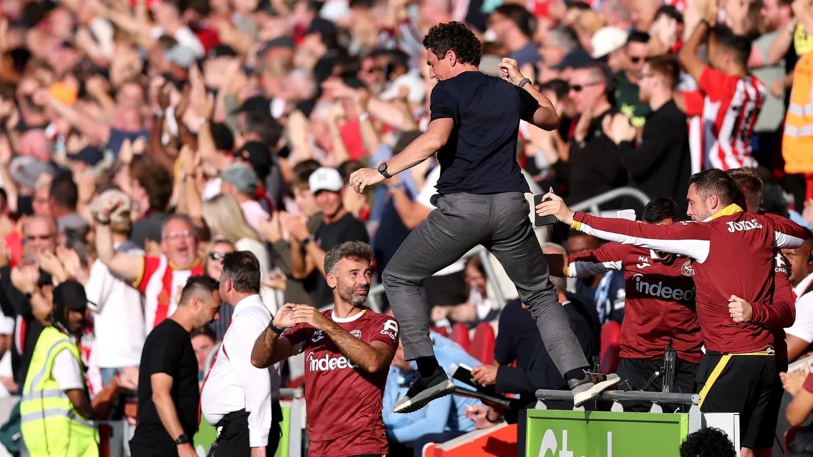 Manager celebrating with fans during a match