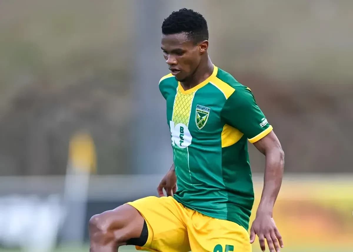 Player in green and yellow kit during match