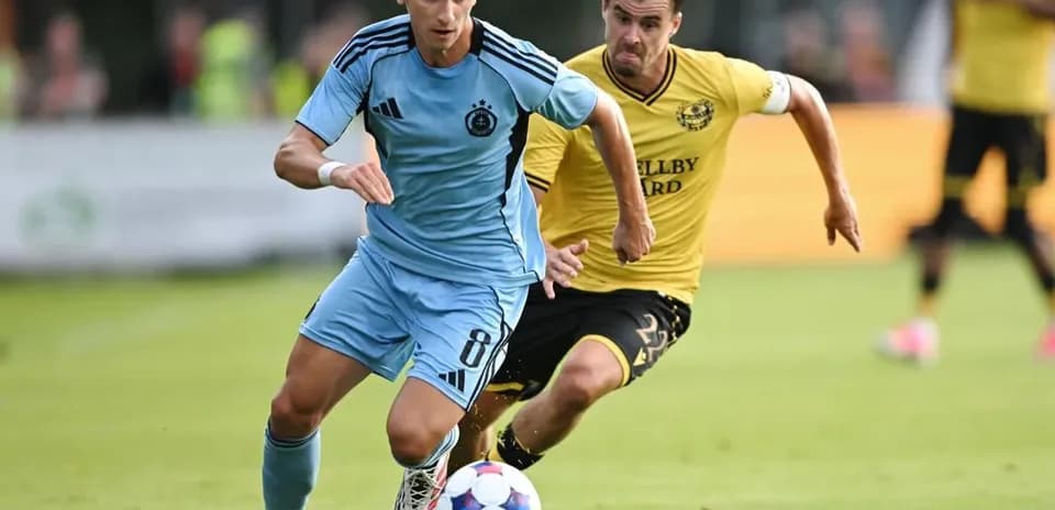 Slovan Bratislava player dribbling past Mjallby AIF opponent
