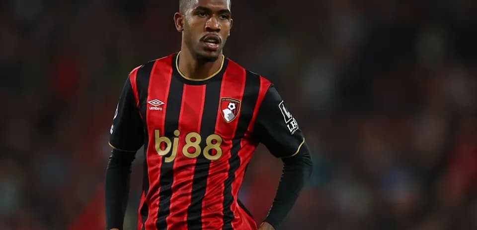 Bournemouth player wearing red and black kit on field