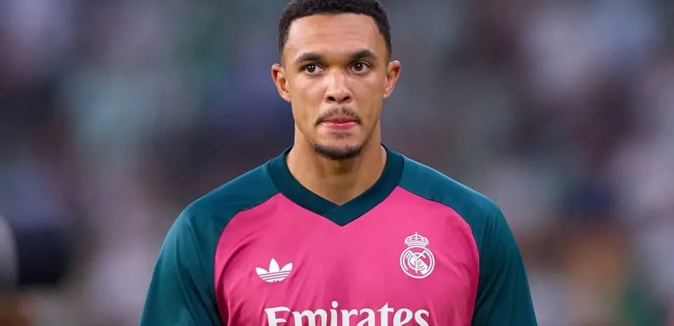 Goalkeeper in pink kit during match warm-up