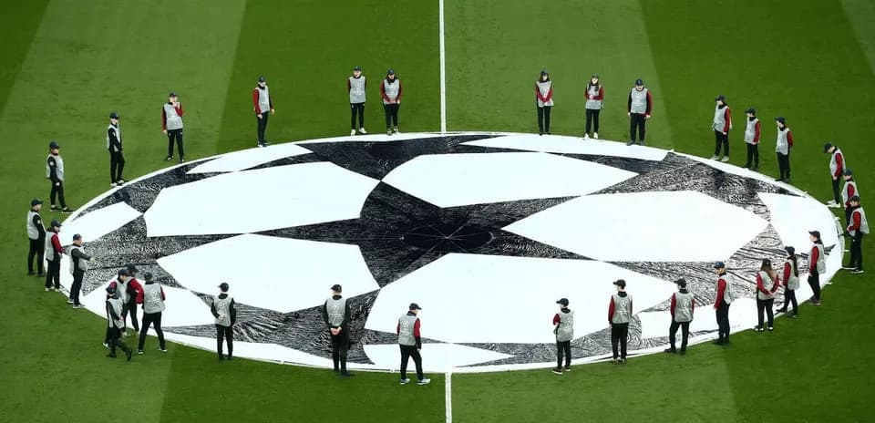 Ground staff preparing Champions League logo on field