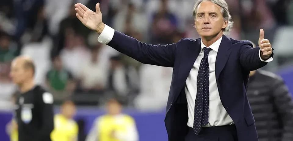Coach gesturing during a football match on the sideline