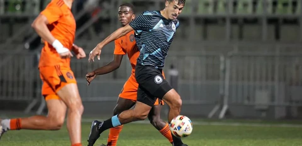 Tacoma Defiance player dribbling past Houston Dynamo FC II