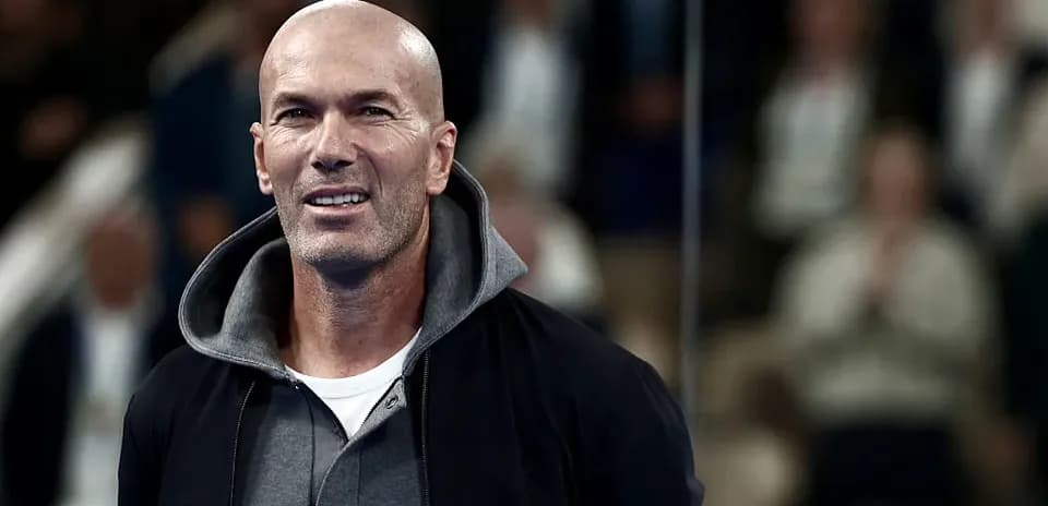 Man smiling while standing in a crowded venue