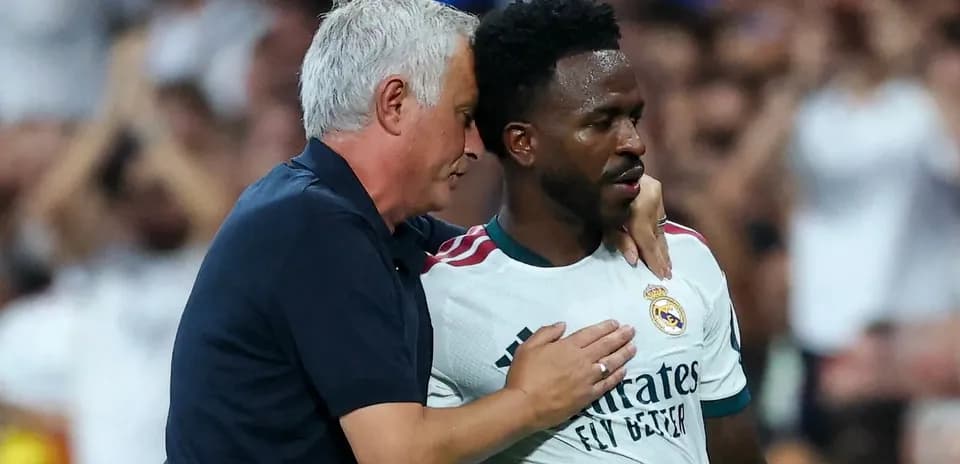 Manager speaking to player during match on field