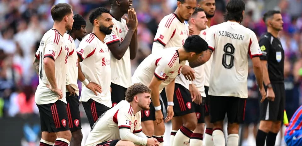 Players in white jerseys preparing for a free kick
