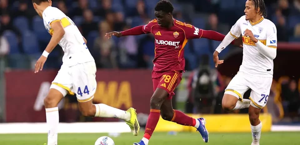 Player dribbling past two opponents during match