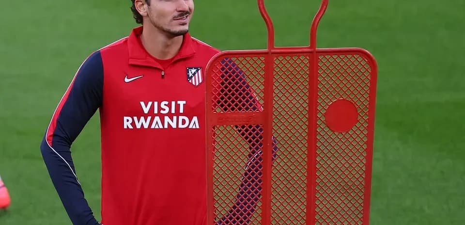 Player standing next to training dummy during practice