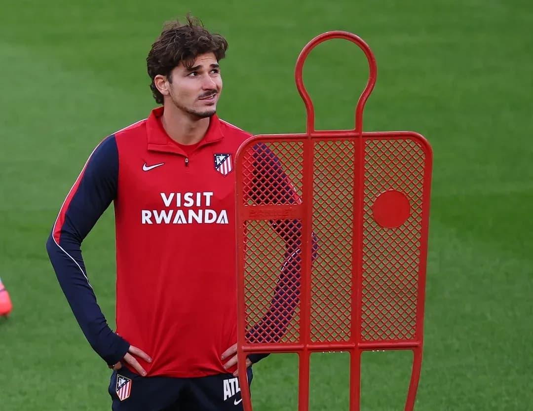 Player standing next to training dummy during practice
