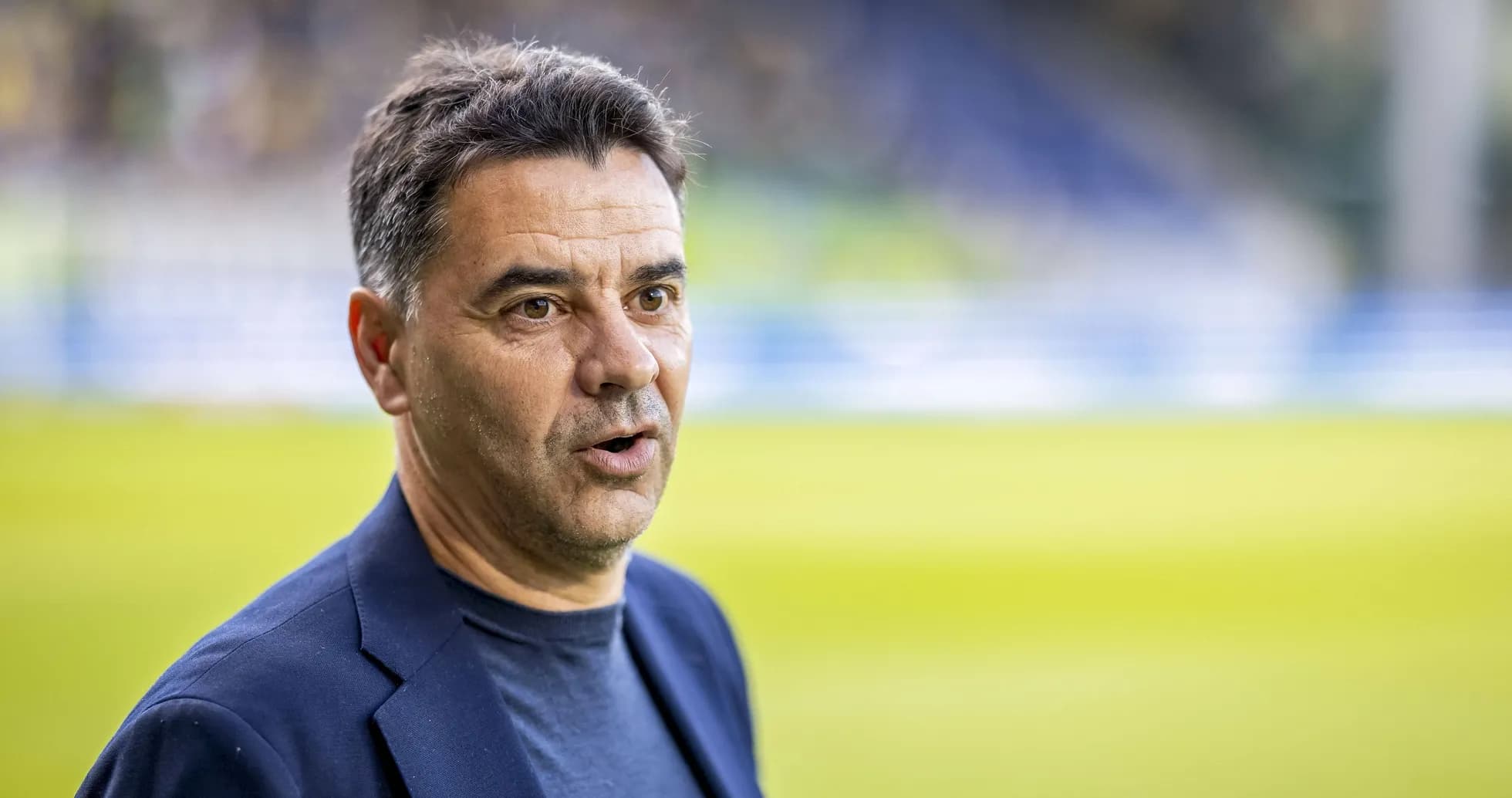 Coach speaking on the sidelines during a match