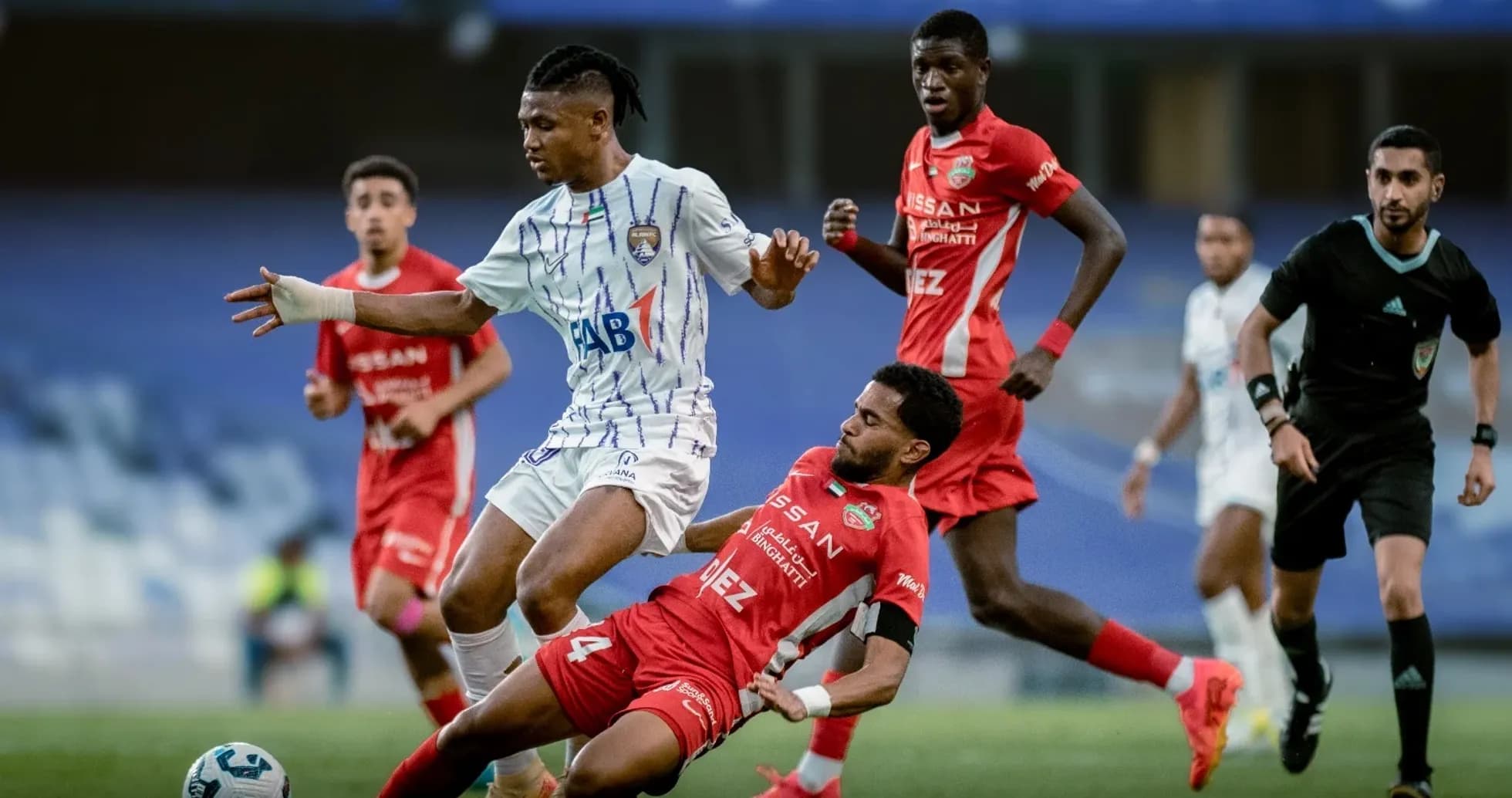 Player tackling opponent during U23 football match