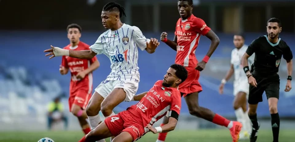 Player tackling opponent during U23 football match