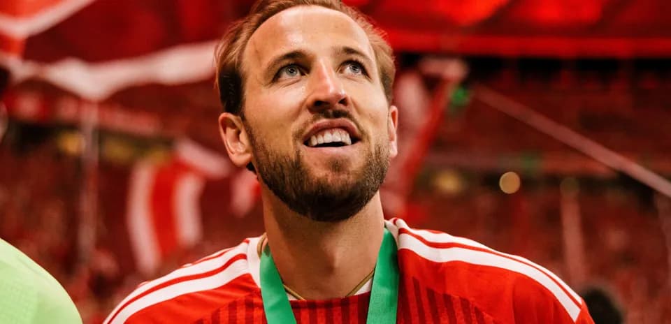 Player wearing red jersey celebrating with medal