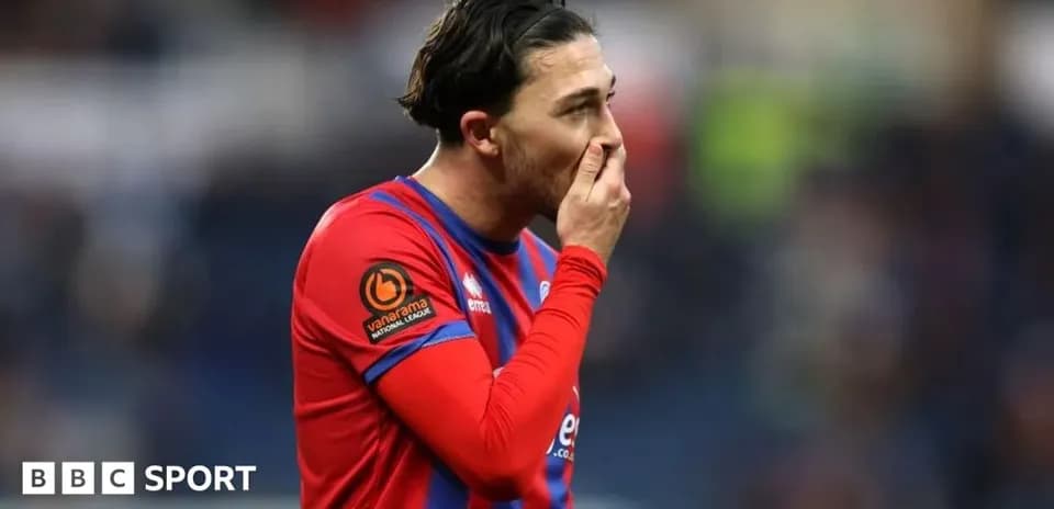 Player in red jersey reacting during a match