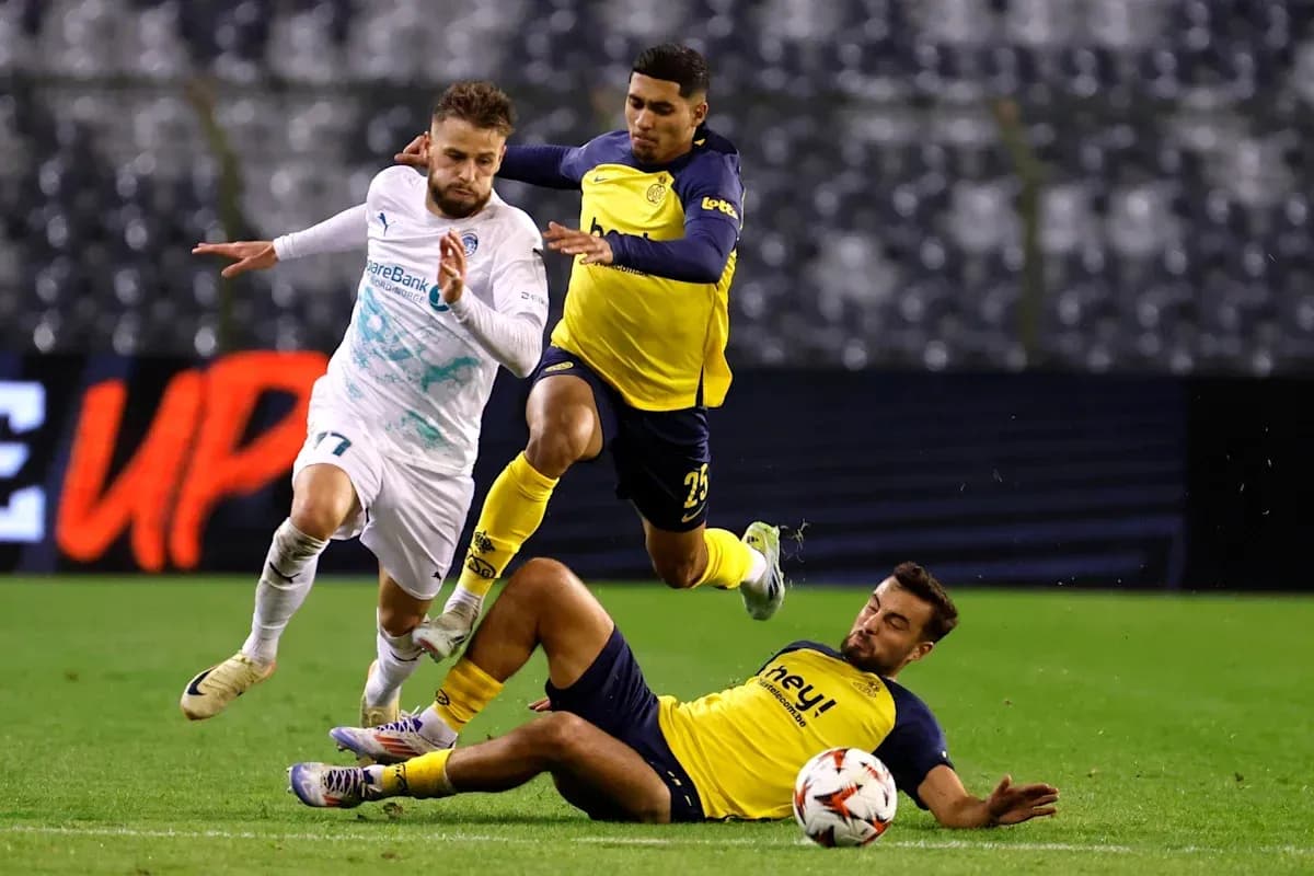 Player evading tackle during intense football match